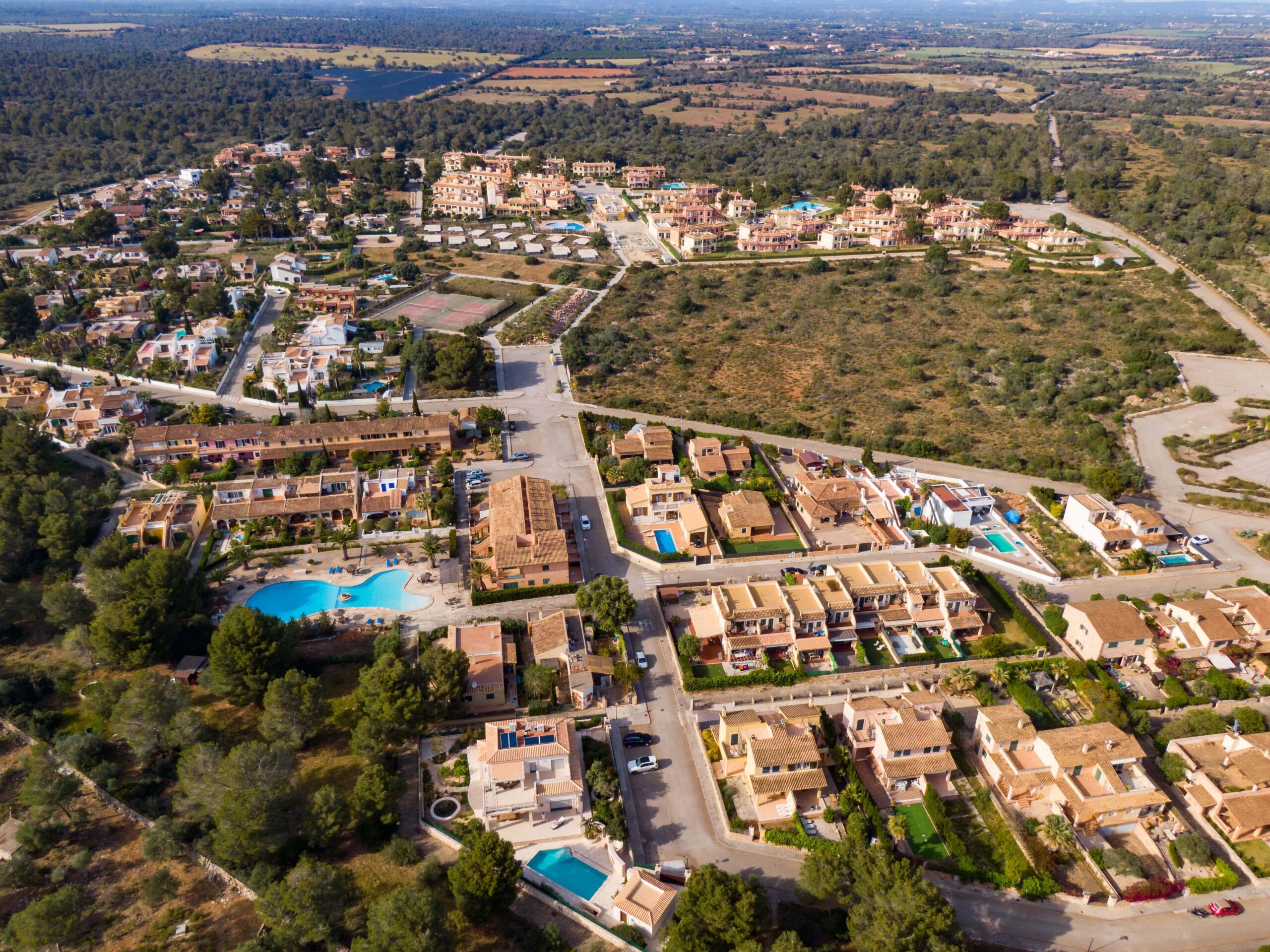 Aerial view of luxury residential real estate development in Cyprus with villas and swimming pools