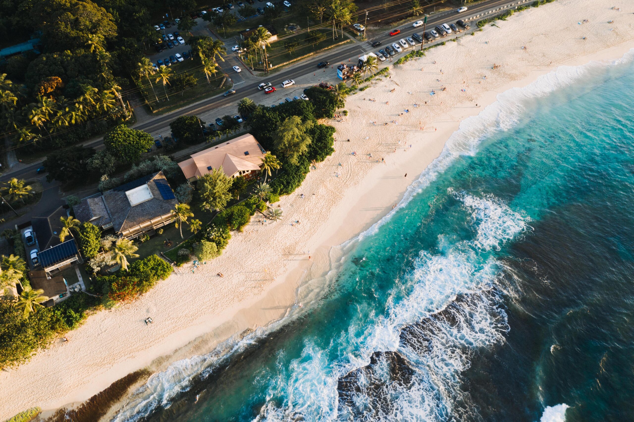 Aerial view of beachfront property with turquoise waters and sandy beach in Cyprus, perfect for real estate investment