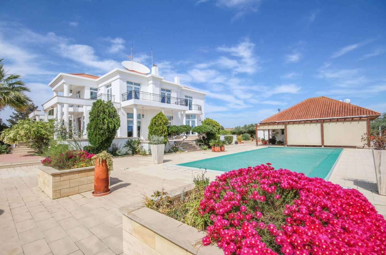 Luxury villa with pool and garden in Cyprus under blue sky