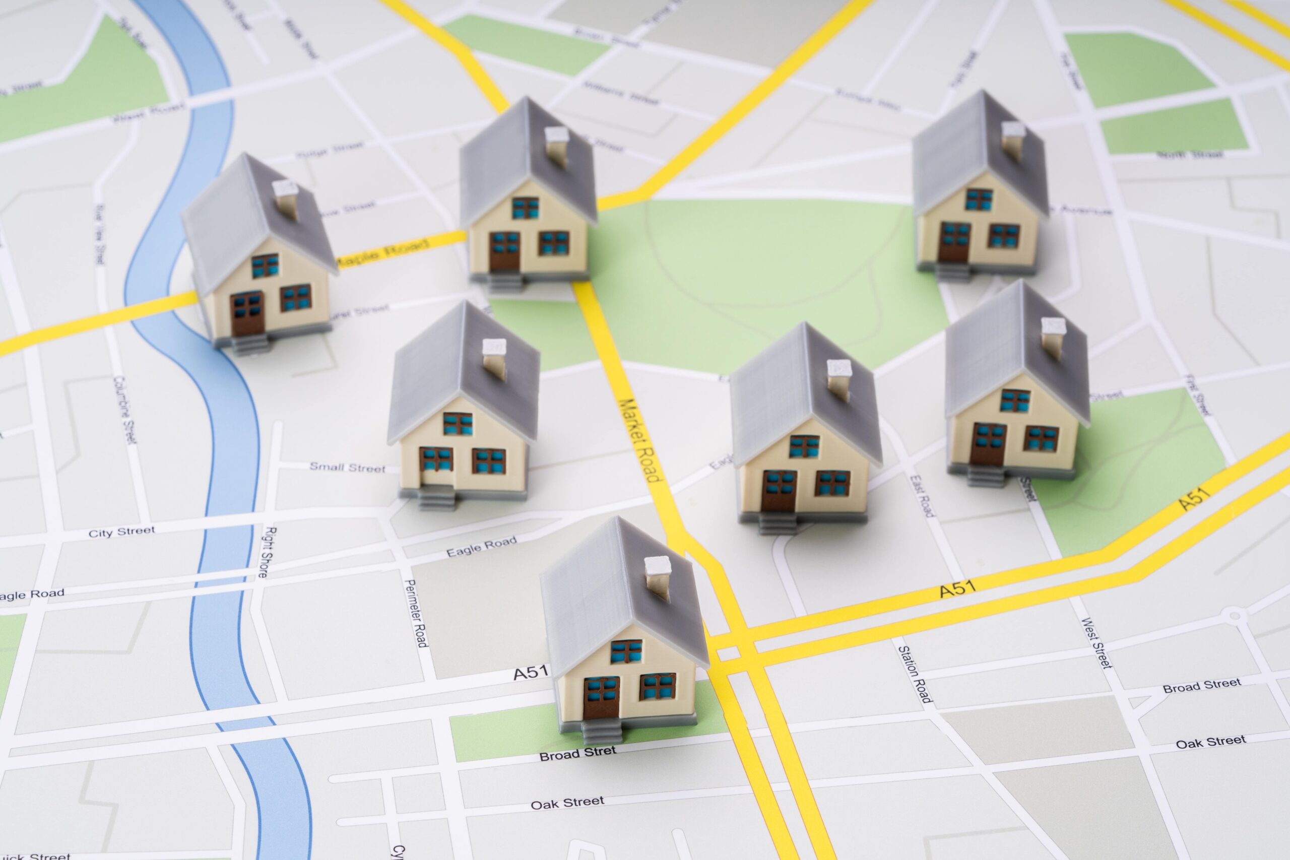 Miniature houses placed on a city map representing real estate options in the Larnaca property market.