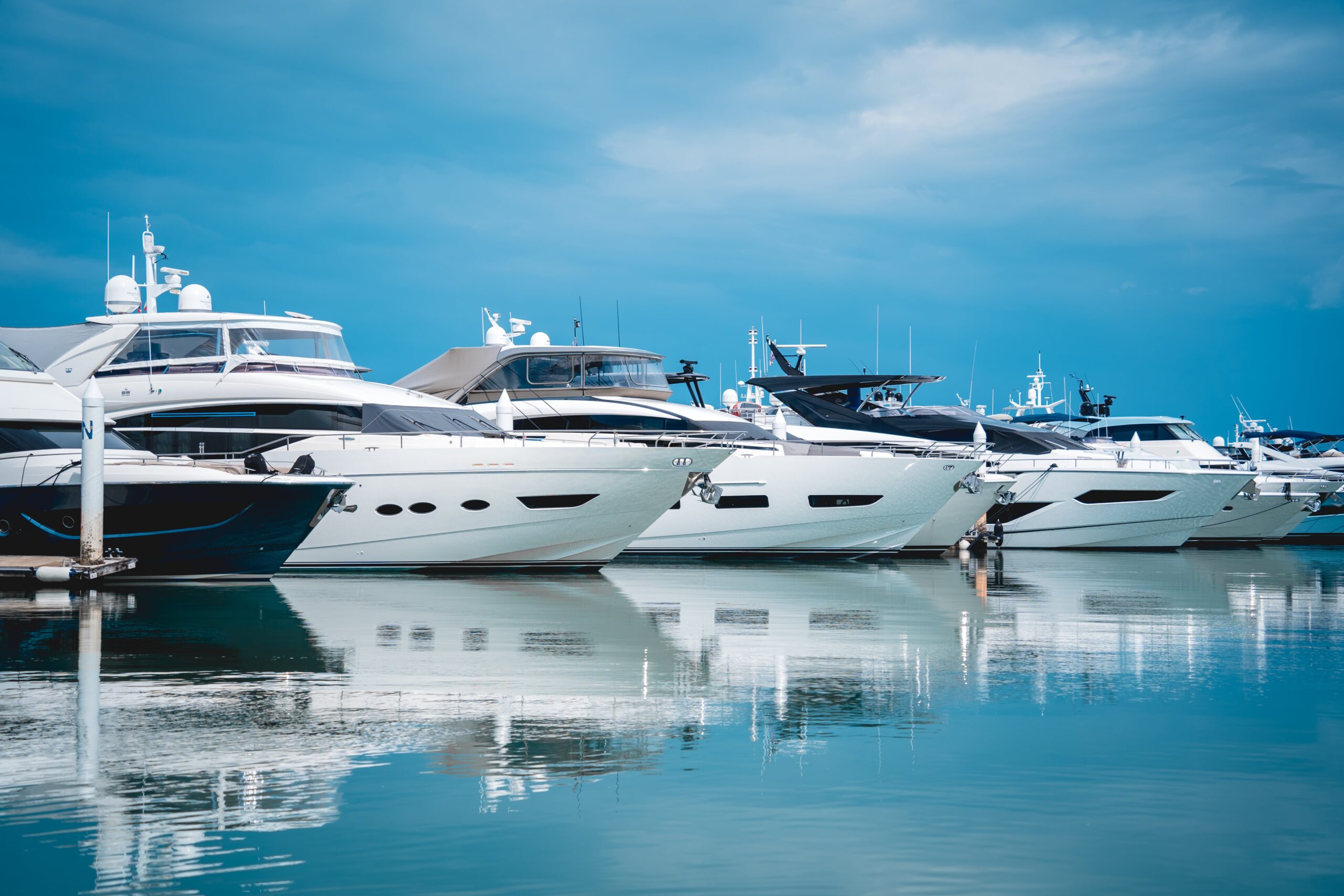 Luxury yachts docked at Cyprus Larnaca Marina under a clear blue sky.