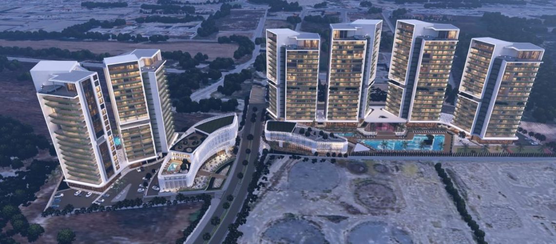 Aerial view of a modern residential and commercial development project in Cyprus featuring multiple high-rise buildings and luxury amenities